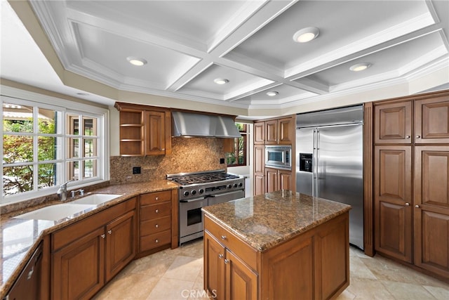 26021 Flintlock Ln, Laguna Hills, CA 92653 - kitchen with built in appliances, wall chimney exhaust hood, a sink, brown cabinets, and coffered ceiling