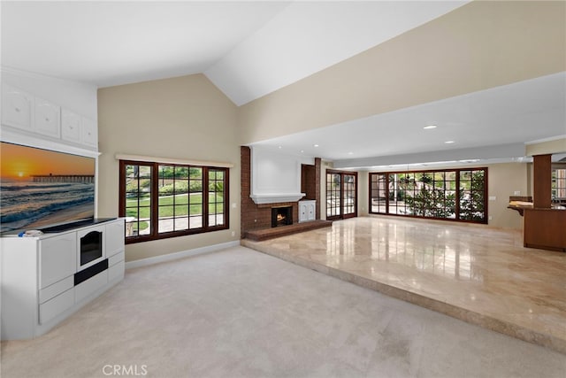 26021 Flintlock Ln, Laguna Hills, CA 92653 - unfurnished living room with a brick fireplace, healthy amount of natural light, light colored carpet, high vaulted ceiling, and recessed lighting