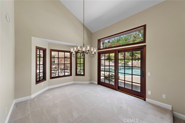 26021 Flintlock Ln, Laguna Hills, CA 92653 - unfurnished dining area with a chandelier, high vaulted ceiling, carpet, and baseboards