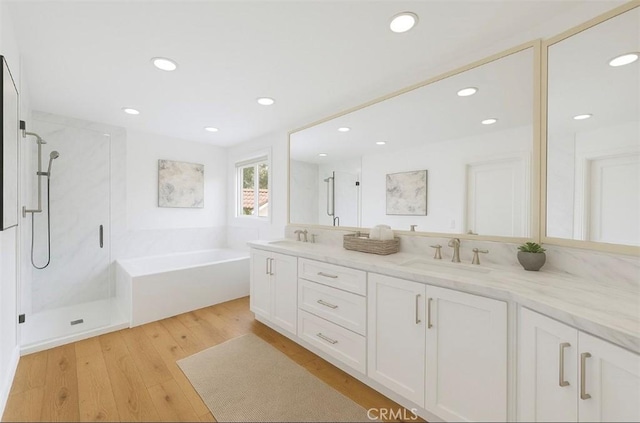 26021 Flintlock Ln, Laguna Hills, CA 92653 - bathroom with a shower stall, a garden tub, double vanity, recessed lighting, and wood finished floors