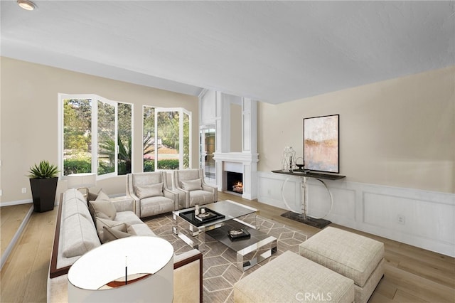 26021 Flintlock Ln, Laguna Hills, CA 92653 - living room with wood finished floors, a fireplace, a wainscoted wall, and a decorative wall