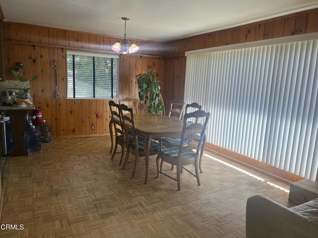 dining room with wooden walls and baseboards