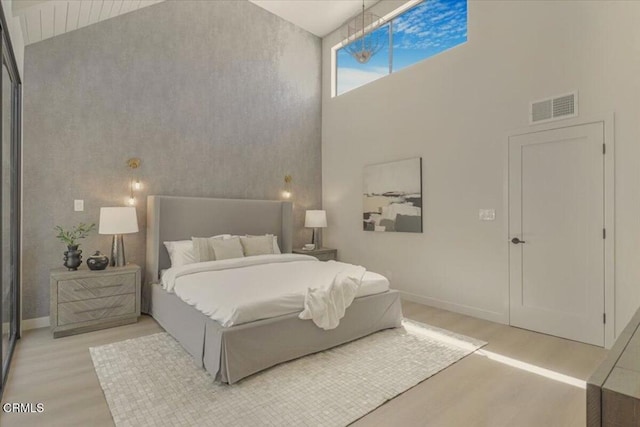 10720 Ohio Ave Unit 5, Los Angeles, CA 90024 - bedroom with light wood finished floors, a high ceiling, and baseboards