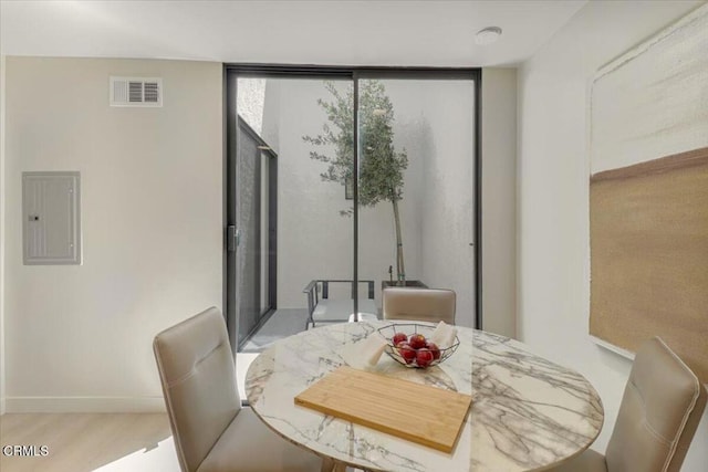 10720 Ohio Ave Unit 5, Los Angeles, CA 90024 - dining area featuring electric panel, wood finished floors, baseboards, and expansive windows