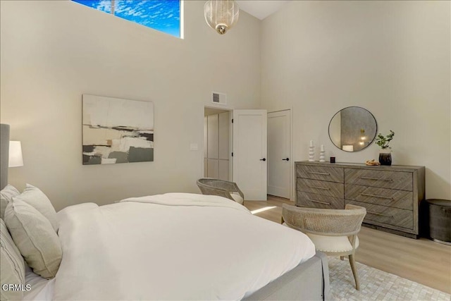10720 Ohio Ave Unit 5, Los Angeles, CA 90024 - bedroom with a towering ceiling and light wood-style flooring