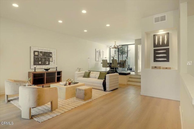 10720 Ohio Ave Unit 5, Los Angeles, CA 90024 - living area with light wood-style floors, a chandelier, and recessed lighting