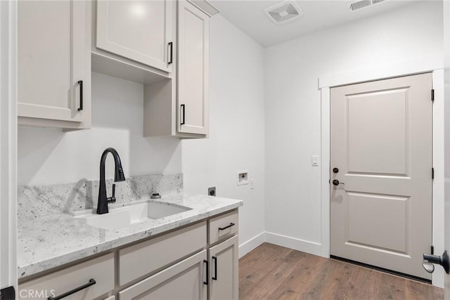 576 Roberts Rd, Paradise, CA 95969 - laundry room with electric dryer hookup, hookup for a washing machine, cabinet space, light wood finished floors, and baseboards