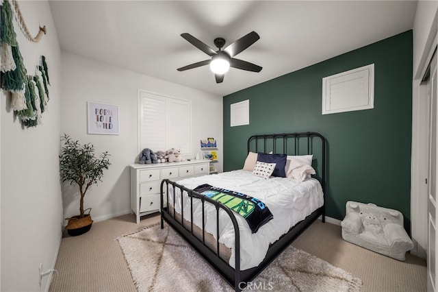bedroom featuring light colored carpet, ceiling fan, and baseboards