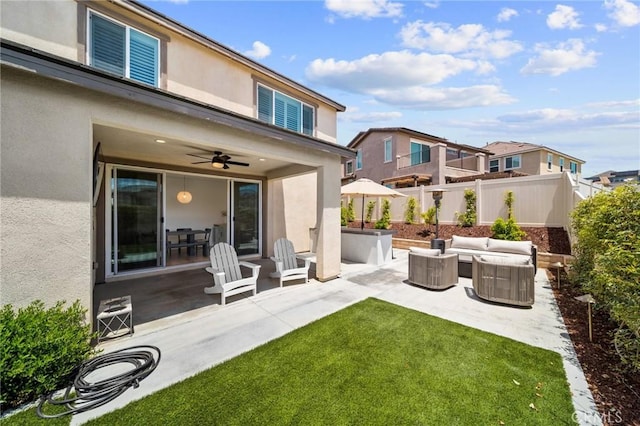 back of house with stucco siding, a patio area, and ceiling fan