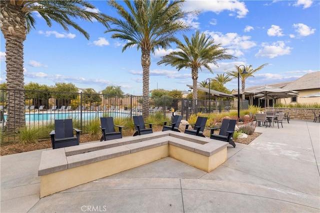 view of patio / terrace with a community pool and outdoor dining space