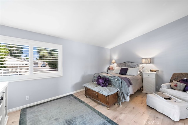 3340 E Collins Ave Unit 30, Orange, CA 92867 - bedroom with light wood-type flooring, vaulted ceiling, and baseboards
