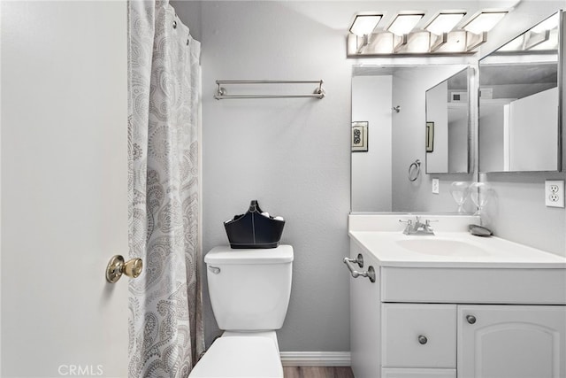 3340 E Collins Ave Unit 30, Orange, CA 92867 - bathroom featuring vanity, toilet, wood finished floors, and baseboards