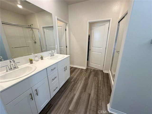 24555 Bravery Cir, Menifee, CA 92584 - full bath with a stall shower, wood finished floors, double vanity, and baseboards