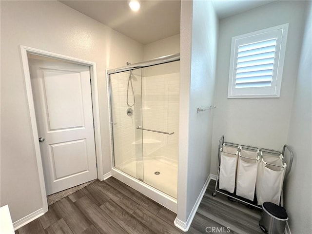 24555 Bravery Cir, Menifee, CA 92584 - bathroom featuring wood finished floors, a stall shower, and baseboards