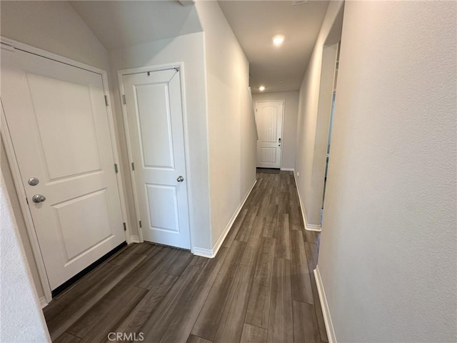 24555 Bravery Cir, Menifee, CA 92584 - hallway with dark wood-style flooring, baseboards, and recessed lighting