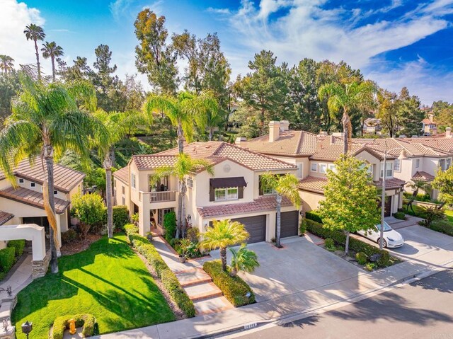 26395 Marsala Way, Mission Viejo, CA 92692 - mediterranean / spanish home with a tiled roof, stucco siding, driveway, an attached garage, and a balcony