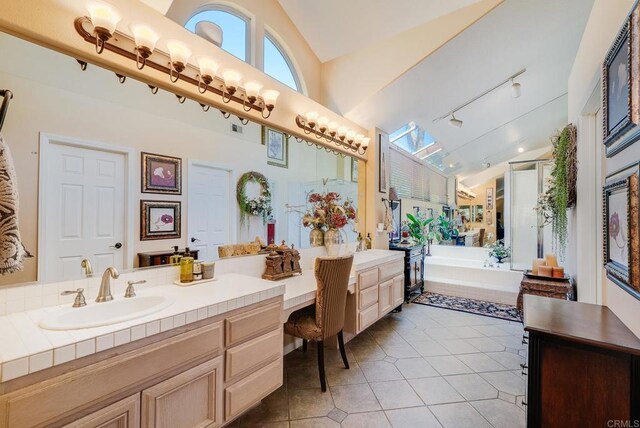 26395 Marsala Way, Mission Viejo, CA 92692 - full bathroom with tile patterned floors, high vaulted ceiling, rail lighting, a garden tub, and vanity