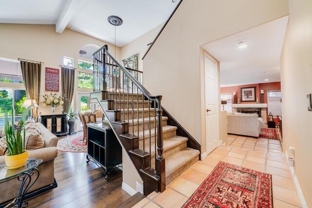 26395 Marsala Way, Mission Viejo, CA 92692 - staircase with beam ceiling, baseboards, high vaulted ceiling, and recessed lighting