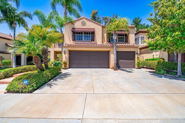 26395 Marsala Way, Mission Viejo, CA 92692 - mediterranean / spanish-style house featuring an attached garage, stucco siding, a tile roof, and driveway