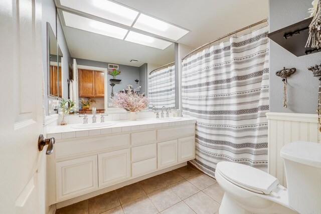 26395 Marsala Way, Mission Viejo, CA 92692 - full bathroom featuring toilet, tile patterned floors, double vanity, and wainscoting