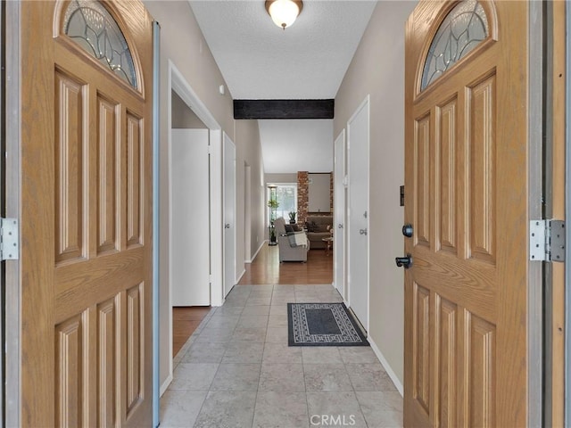entrance foyer with baseboards and light tile patterned floors