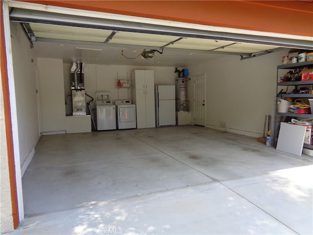 garage with separate washer and dryer, heating unit, water heater, and a garage door opener