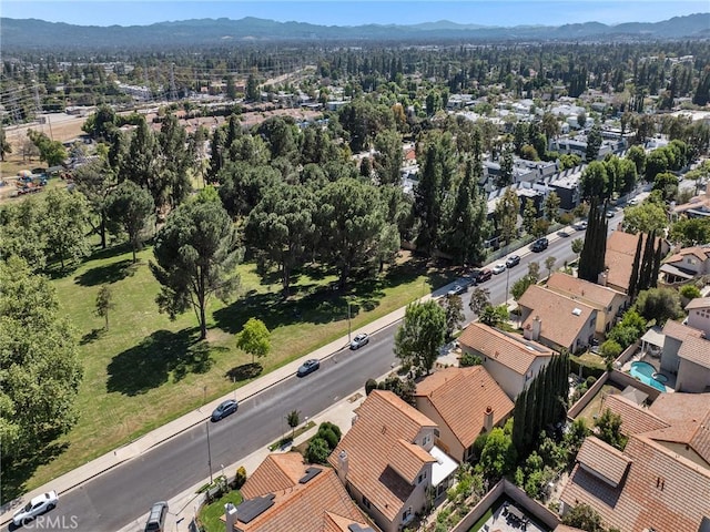 aerial view of property and surrounding area with mountains and nearby suburban area