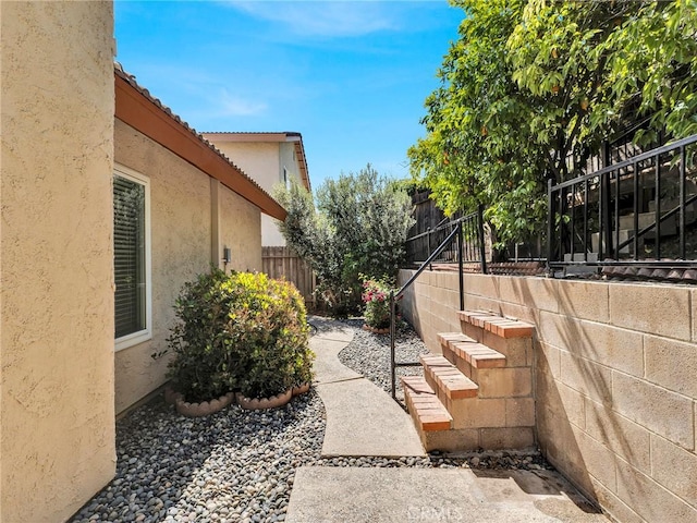 view of home's exterior with stucco siding and a tile roof