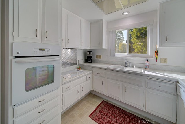 378 Avenida Castilla Unit O, Laguna Woods, CA 92637 - kitchen featuring white appliances, light countertops, white cabinets, a sink, and recessed lighting