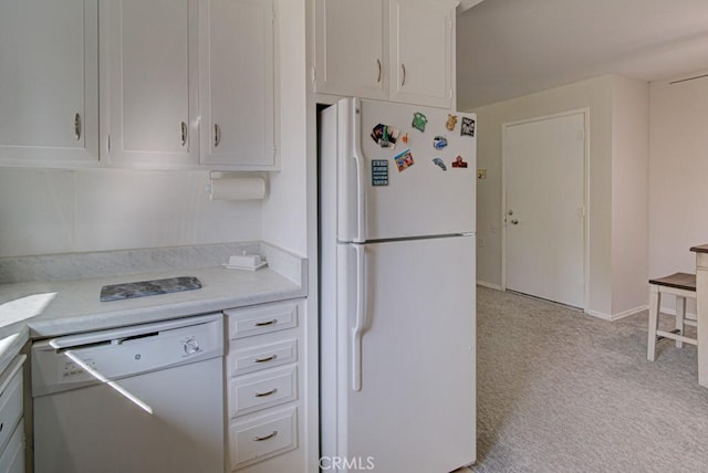 378 Avenida Castilla Unit O, Laguna Woods, CA 92637 - kitchen featuring white appliances, light countertops, light carpet, and white cabinetry