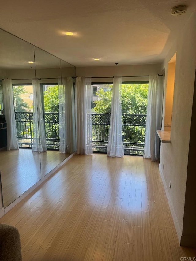 1355 N Sierra Bonita Ave Unit 204, West Hollywood, CA 90046 - spare room with a smoke detector, healthy amount of natural light, and light wood-type flooring