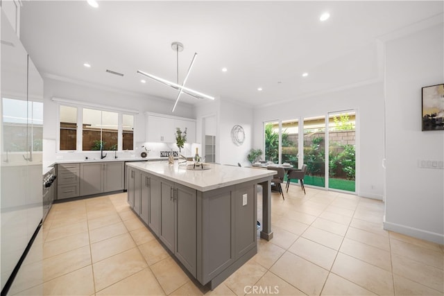 112 Turning Post, Irvine, CA 92620 - kitchen with gray cabinets, a center island with sink, recessed lighting, light tile patterned floors, and a sink