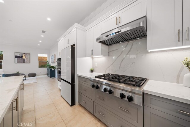 112 Turning Post, Irvine, CA 92620 - kitchen with under cabinet range hood, appliances with stainless steel finishes, gray cabinetry, decorative backsplash, and light stone counters