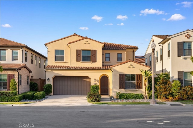 112 Turning Post, Irvine, CA 92620 - mediterranean / spanish-style home with a tile roof, an attached garage, stucco siding, and concrete driveway