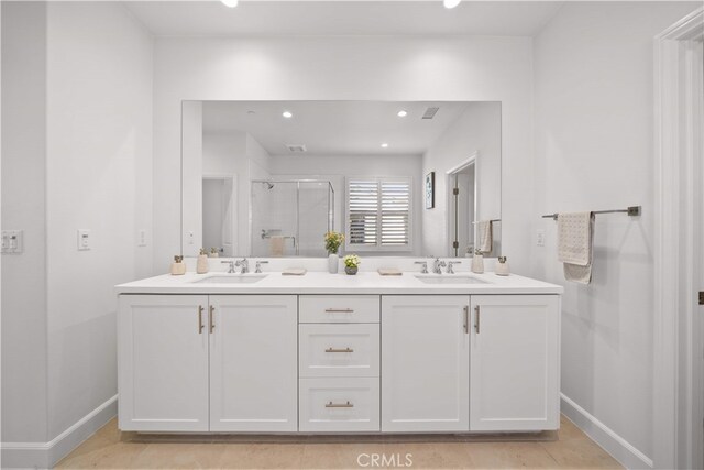 112 Turning Post, Irvine, CA 92620 - bathroom with double vanity, baseboards, a stall shower, and recessed lighting