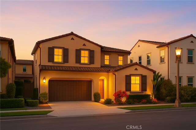 112 Turning Post, Irvine, CA 92620 - view of front of home with an attached garage, stucco siding, a tiled roof, and concrete driveway