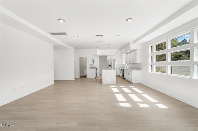 1944 Seminole Dr, Agoura Hills, CA 91301 - unfurnished living room with light wood-style floors, baseboards, and recessed lighting