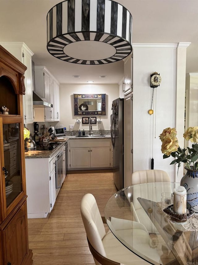 7975 Playmor Ter, San Diego, CA 92122 - kitchen featuring black appliances, a sink, light wood-type flooring, and dark stone countertops