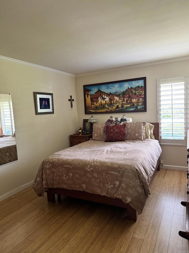 7975 Playmor Ter, San Diego, CA 92122 - bedroom featuring ornamental molding, wood finished floors, and baseboards