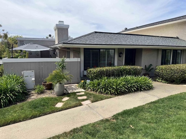7975 Playmor Ter, San Diego, CA 92122 - view of front of home with fence, a shingled roof, stucco siding, and a chimney