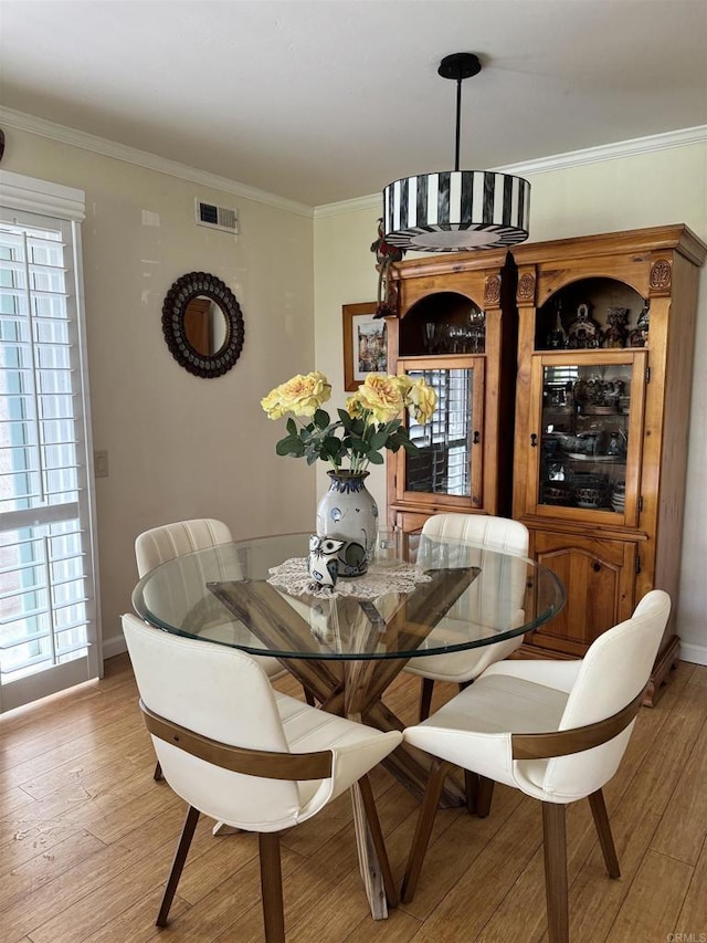 7975 Playmor Ter, San Diego, CA 92122 - dining space with light wood-style floors, crown molding, and baseboards