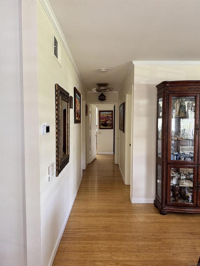 7975 Playmor Ter, San Diego, CA 92122 - hallway featuring ornamental molding, baseboards, and light wood-style floors