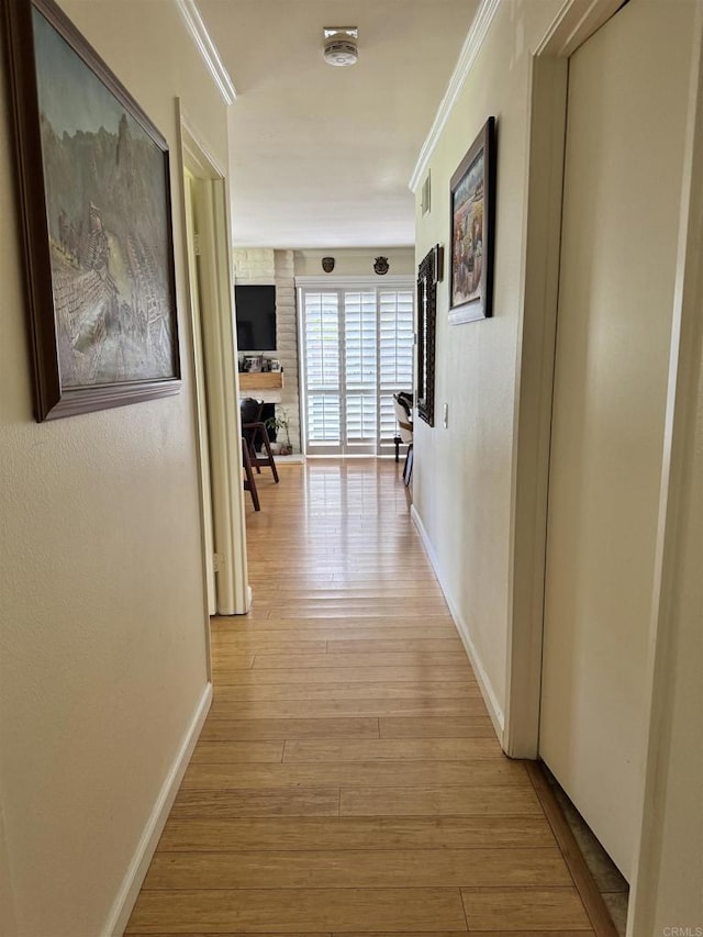 7975 Playmor Ter, San Diego, CA 92122 - hallway featuring crown molding, light wood-type flooring, and baseboards