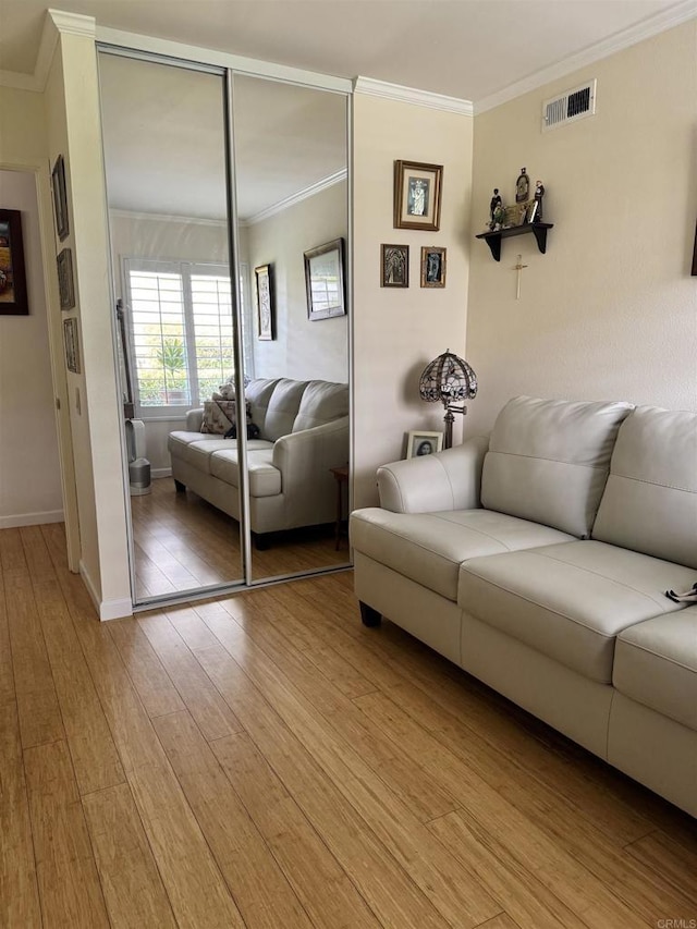 7975 Playmor Ter, San Diego, CA 92122 - living room featuring ornamental molding, light wood finished floors, and baseboards