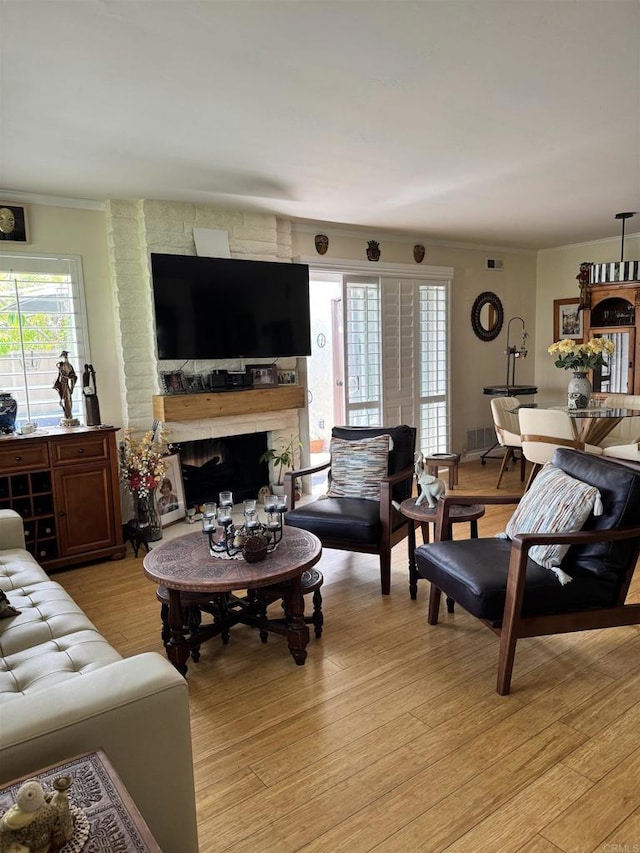 7975 Playmor Ter, San Diego, CA 92122 - living area with a fireplace, light wood-type flooring, and crown molding