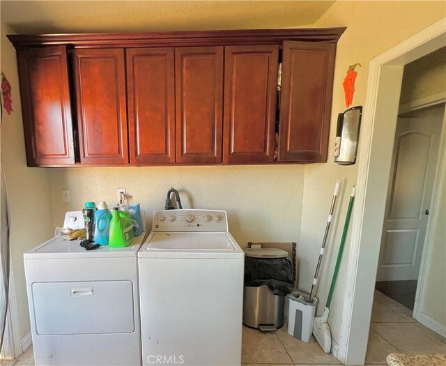 23079 Minnetonka Rd, Apple Valley, CA 92308 - washroom with washing machine and dryer, light tile patterned floors, cabinet space, and baseboards