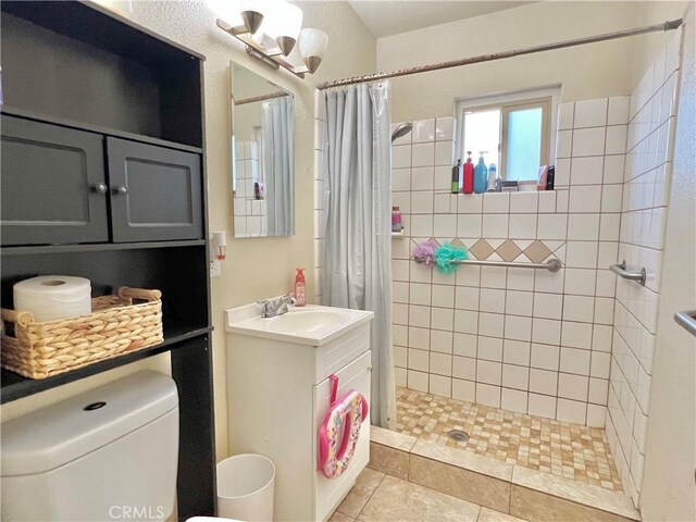 23079 Minnetonka Rd, Apple Valley, CA 92308 - bathroom featuring a stall shower, toilet, vanity, and tile patterned floors