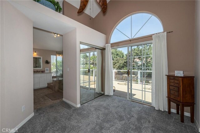 28852 Glenheather Dr, Highland, CA 92346 - empty room with carpet flooring, ceiling fan, baseboards, and a towering ceiling