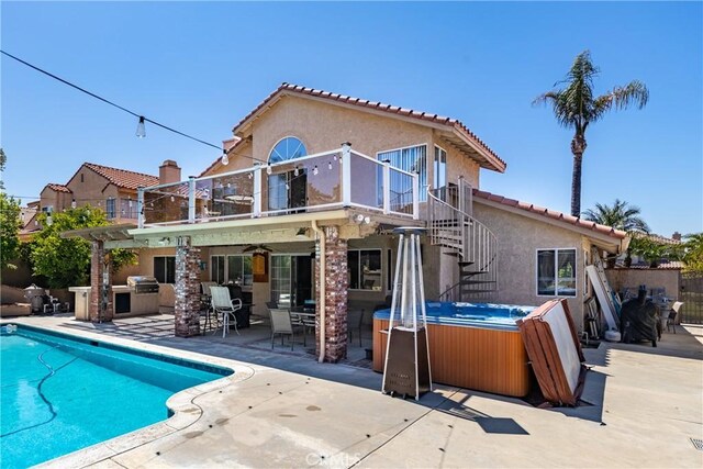 28852 Glenheather Dr, Highland, CA 92346 - back of house with a hot tub, a balcony, a patio area, stucco siding, and ceiling fan