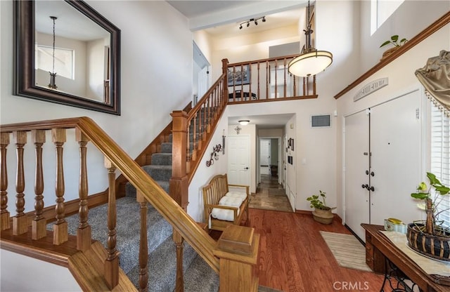 28852 Glenheather Dr, Highland, CA 92346 - foyer with wood finished floors, a high ceiling, stairs, and baseboards